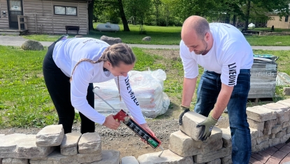 Days of Caring volunteers complete a project at the Boy Scouts camp